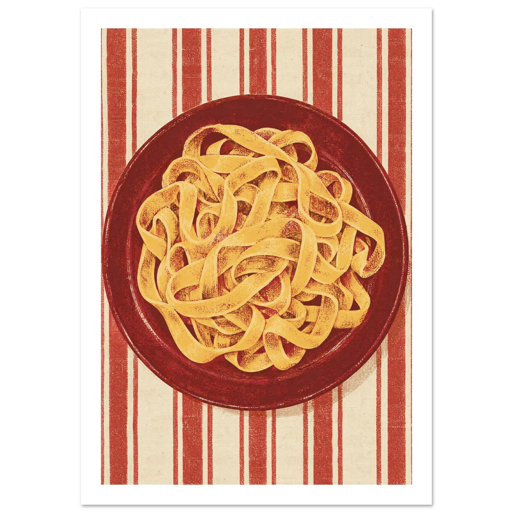 Golden pasta ribbons on a deep red plate, viewed from above against textured red and cream vertical stripes.