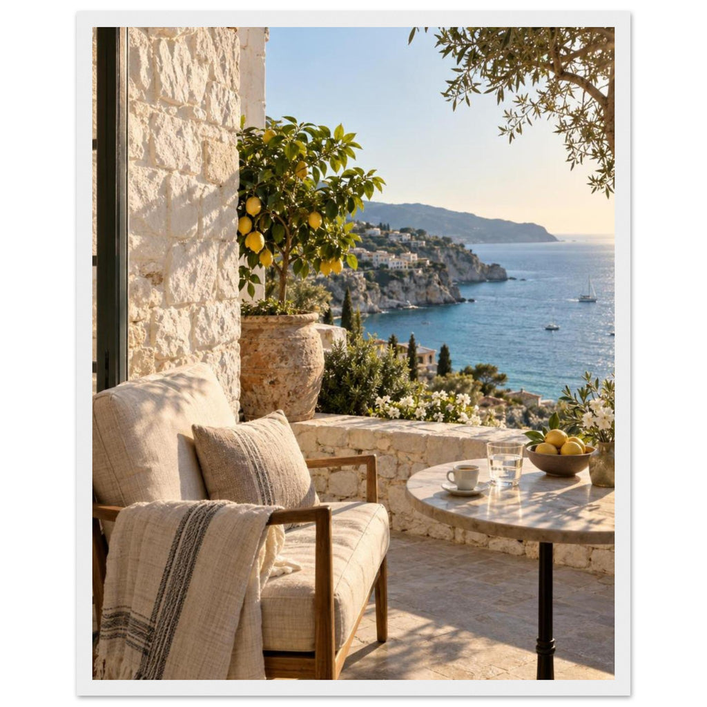 Lemon tree on a stone terrace with a cushioned chair, round table and blue sea overlooking a rocky coastline.