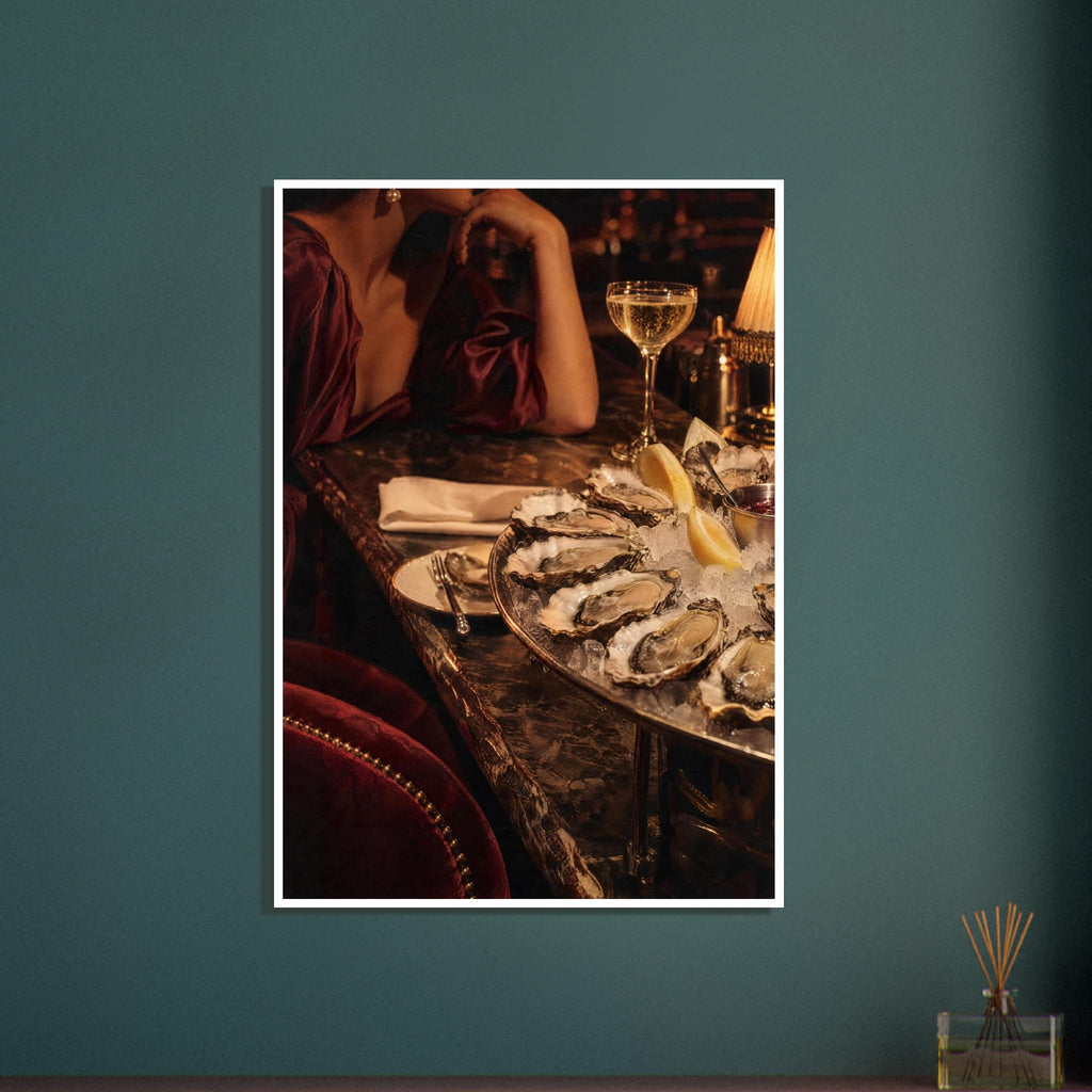 Oysters on ice with lemon wedges, sparkling wine and a glowing lamp beside a cropped figure in a burgundy dress.