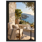 Lemon tree on a stone terrace with a cushioned chair, round table and blue sea overlooking a rocky coastline.