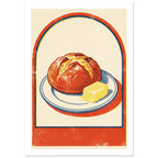 Round loaf and yellow butter on a blue-rimmed plate, with an orange-red arch border and textured cream background.