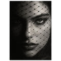 Woman's face behind a diamond-patterned net veil, with one eye brightly lit and the other in deep shadow, in black and white.