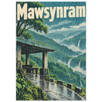 Mawsynram lettering above rain-soaked green hills, waterfalls and a roofed shelter beside a winding wet path.