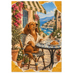 Brown dog in a cream shirt at a café table with coffee and a croissant, overlooking a blue bay with sailing boats.