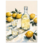 Yellow lemons with green leaves surround a clear bottle and two glasses of pale yellow liquid on a cream tabletop.