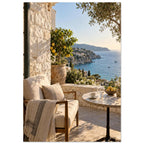 Lemon tree on a stone terrace with a cushioned chair, round table and blue sea overlooking a rocky coastline.