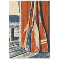 Four weathered red, blue and cream wooden oars leaning against red timber boards beside water and a wooden jetty.