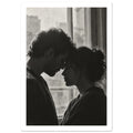 Black and white photograph of a couple touching foreheads beside a window, their profiles softly outlined by daylight.