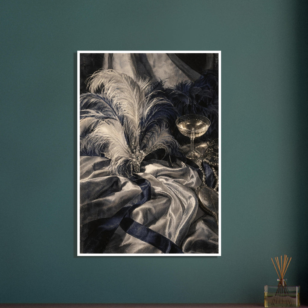 Feathered jewelled mask on draped fabric beside a coupe glass, pearls and an ornate hand mirror in cream, grey and navy.