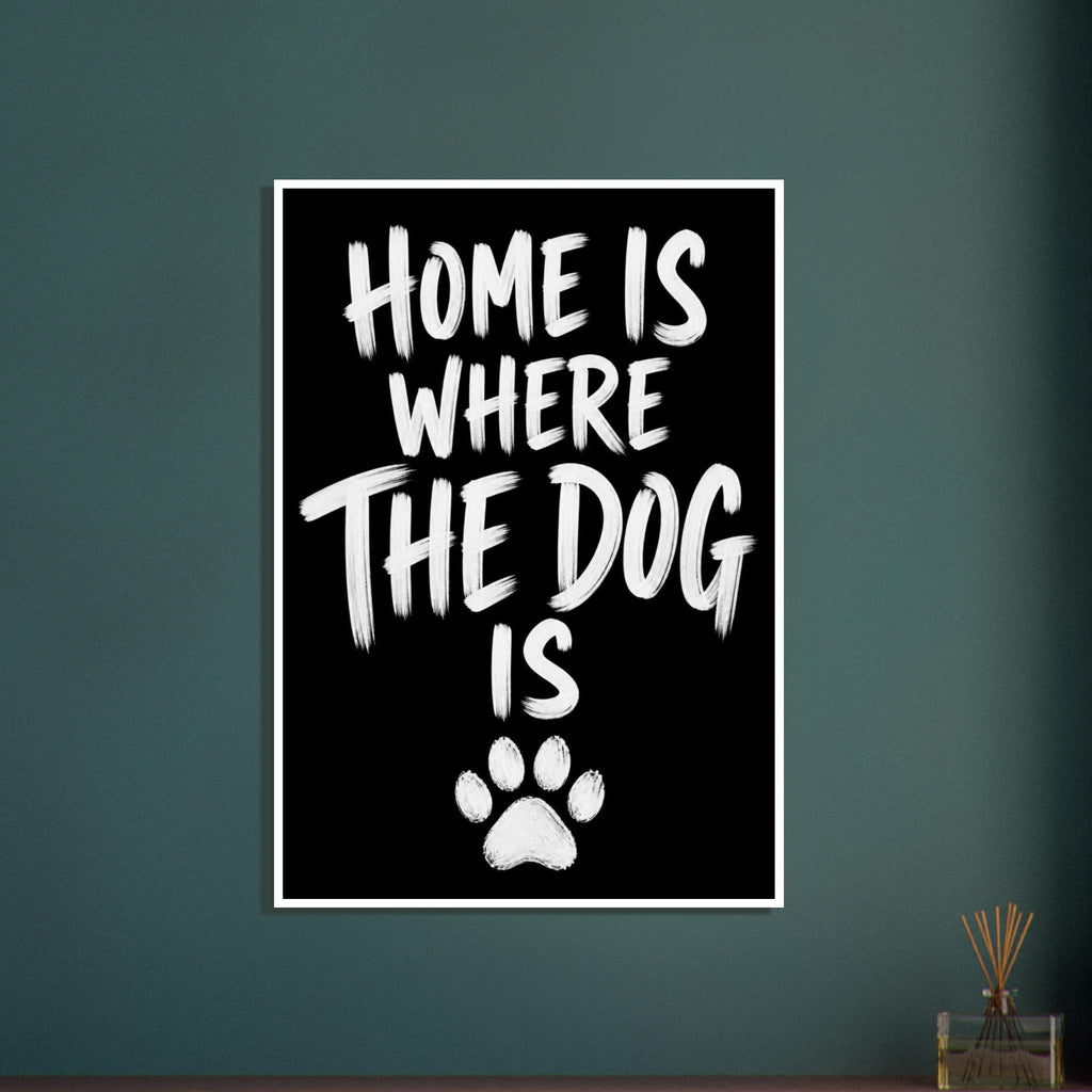 White brush lettering reading “Home is where the dog is” on a black background, with a white paw print below.