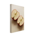 Two red-skinned apple halves with exposed cores on a beige surface, with soft shadows and ample empty space above.