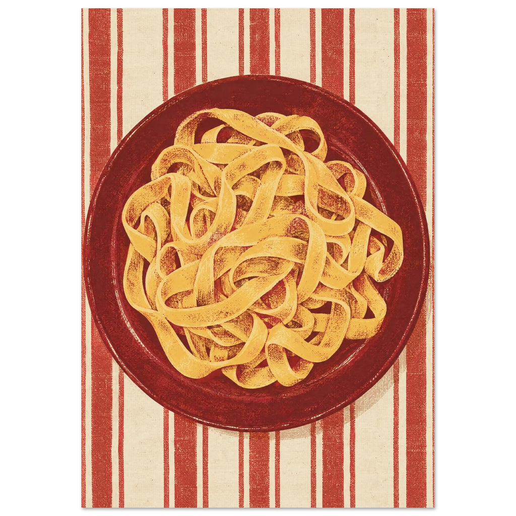 Golden pasta ribbons on a deep red plate, viewed from above against textured red and cream vertical stripes.