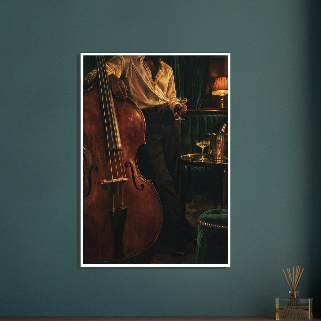 Double bass beside a figure holding a stemmed glass, with dark green seating, a drinks table and a glowing lamp.