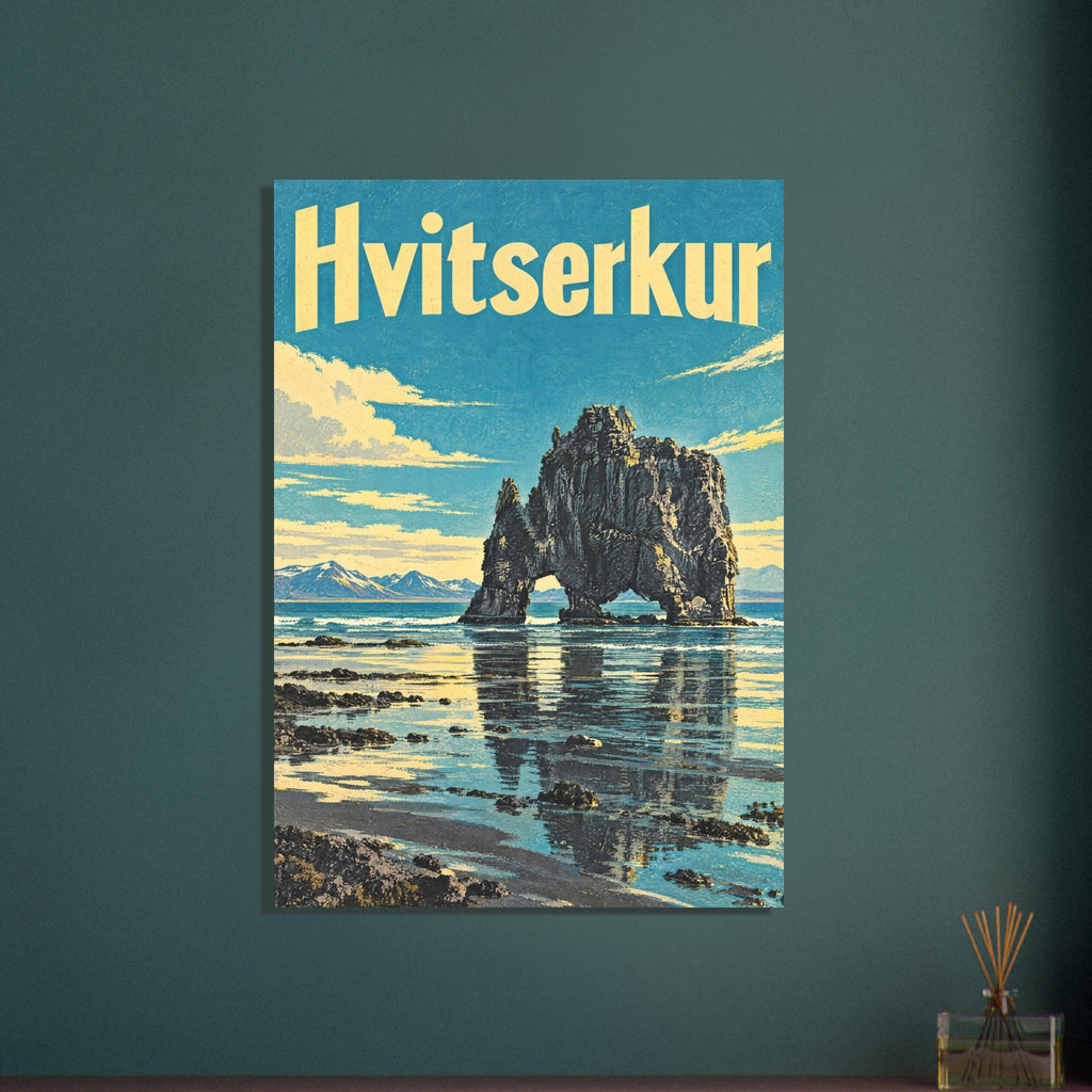 Hvitserkur lettering above a dark arched sea stack reflected in shallow water, with turquoise sky and yellow clouds.