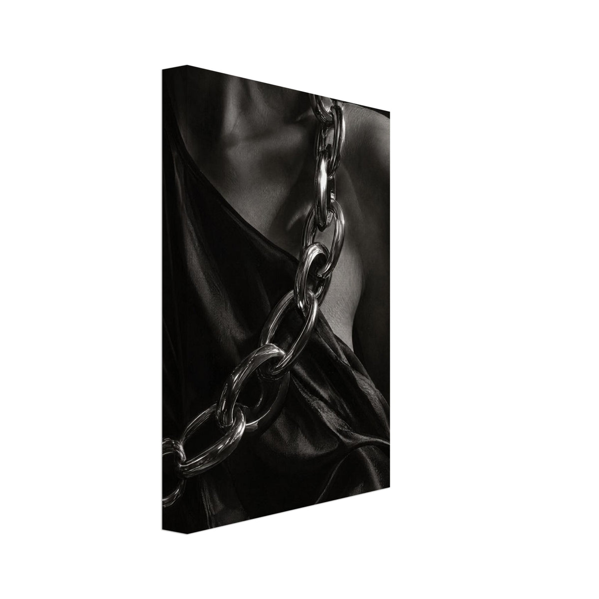 Oversized polished chain links cross dark, lustrous fabric beside a bare shoulder and neckline in black and white.