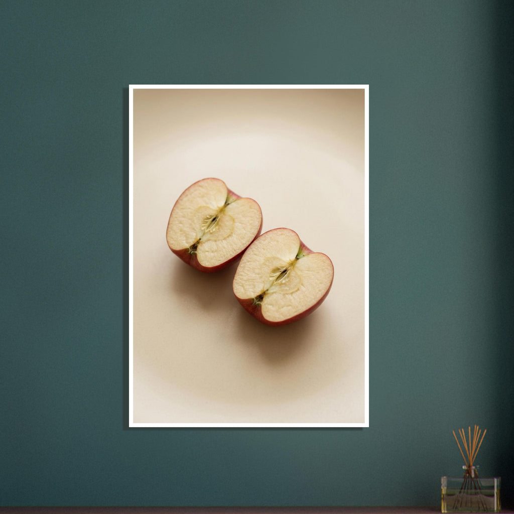 Two red-skinned apple halves with exposed cores on a beige surface, with soft shadows and ample empty space above.