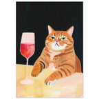 Ginger tabby with green eyes resting its paws on a yellow table beside a glass of pink-red wine against a dark background.