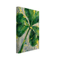 Four leaf clover painted in layered greens with yellow splashes and paint drips on a mottled grey and cream background.
