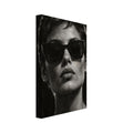 Behind the Sunglasses, a tightly cropped frontal face wearing large geometric sunglasses, with rim-lit short hair against bla