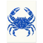 Ultramarine blue crab with raised claws and distressed detailing, centred on a warm cream background.