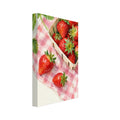 Watercolour strawberries in a wooden punnet on pink gingham cloth, with loose berries, green leaves and a white blossom.