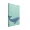 Blue whale swimming through pale aqua water above a sandy seabed with rocks and sea plants, beneath sunlit ripples.