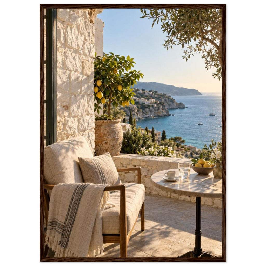 Lemon tree on a stone terrace with a cushioned chair, round table and blue sea overlooking a rocky coastline.