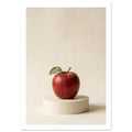 Red apple with a green leaf on a low circular cream plinth, against a cream background with soft shadows.