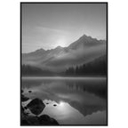 Mountain peaks and conifer forests reflected in a misty lake, with rocks in the foreground, in black and white.