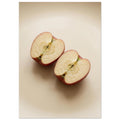 Two red-skinned apple halves with exposed cores on a beige surface, with soft shadows and ample empty space above.