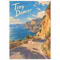 Ballerina dancing on a coastal road beside golden cliffs and blue sea, with cream “Tiny Dancer” lettering in the sky.