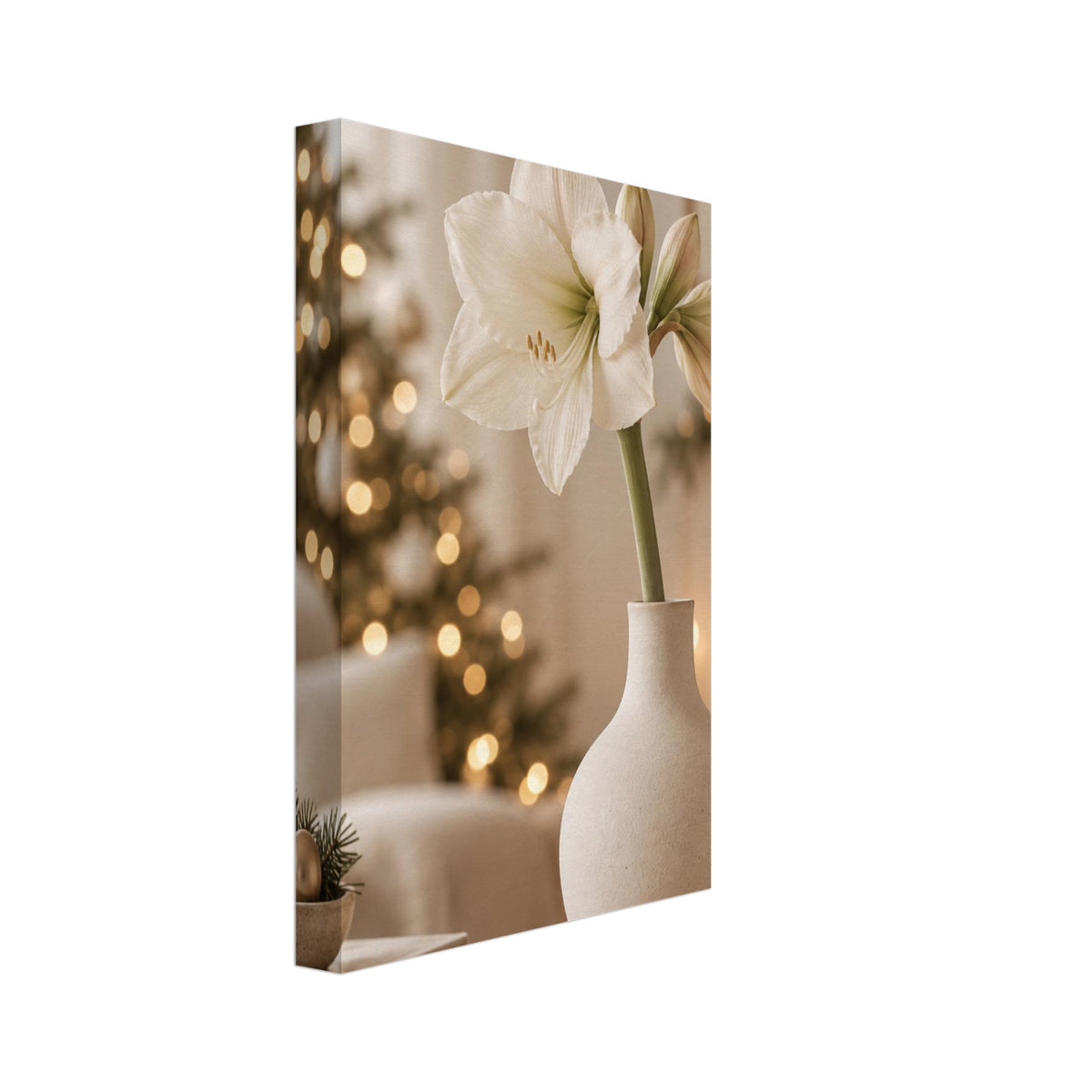 White amaryllis in a cream vase on a wooden table, with a softly blurred Christmas tree and glowing candles behind.