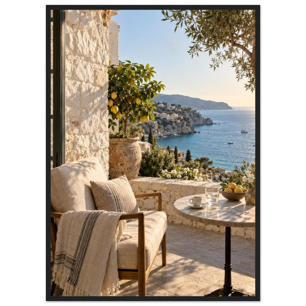 Lemon tree on a stone terrace with a cushioned chair, round table and blue sea overlooking a rocky coastline.