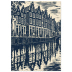 Gabled canal houses in navy and cream, with a street lamp, bicycles, an arched bridge and rippling reflections.