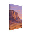 Terracotta desert cliffs above a scrub-covered plain, with distant mesas beneath a lilac and peach sky.