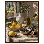 Lemons, olives, figs and a bottle of oil on a stone table beside a ceramic jug of leafy branches and a sunlit window.