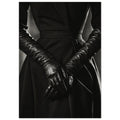 Overlapping hands in long black leather gloves against a dark fitted outfit, photographed in black and white.