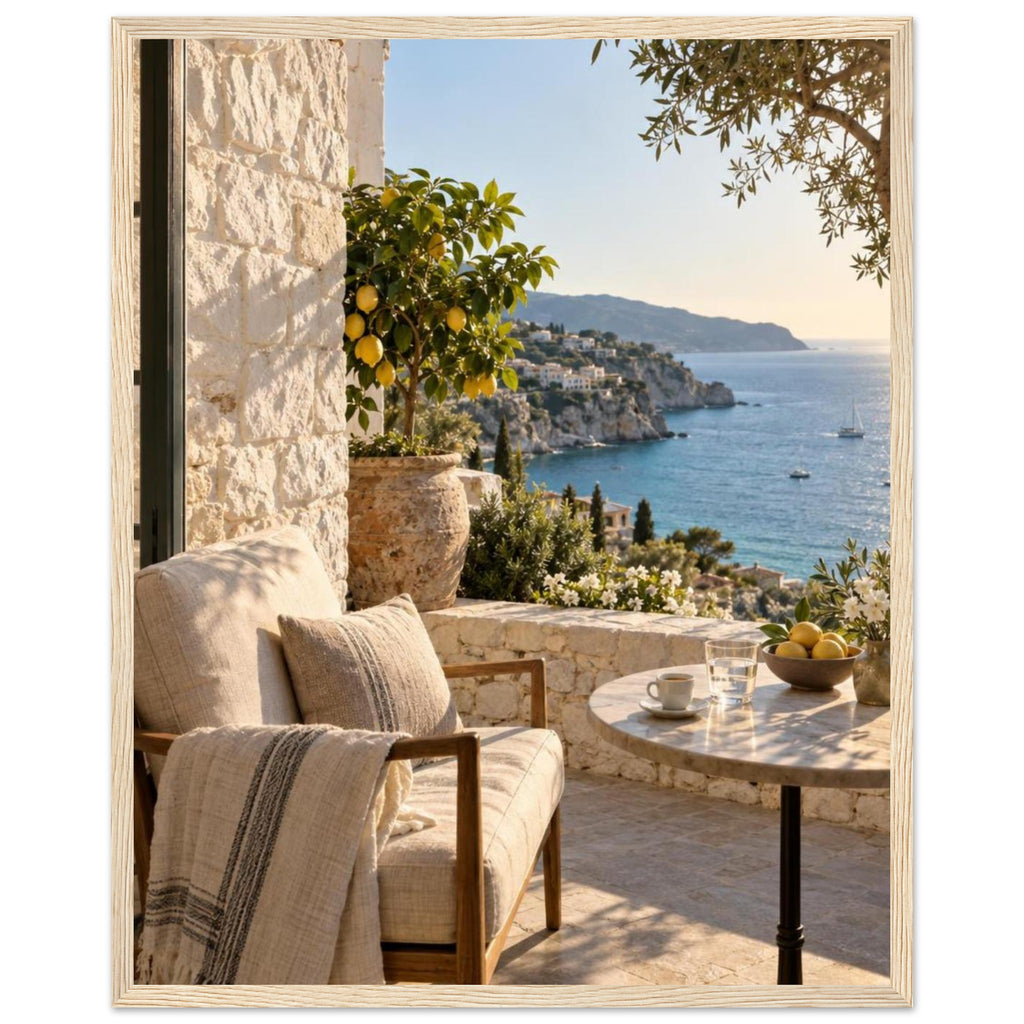 Lemon tree on a stone terrace with a cushioned chair, round table and blue sea overlooking a rocky coastline.