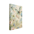 Pastel butterfly with spread wings above pink, blue and white wildflowers in soft green and blue watercolour washes.