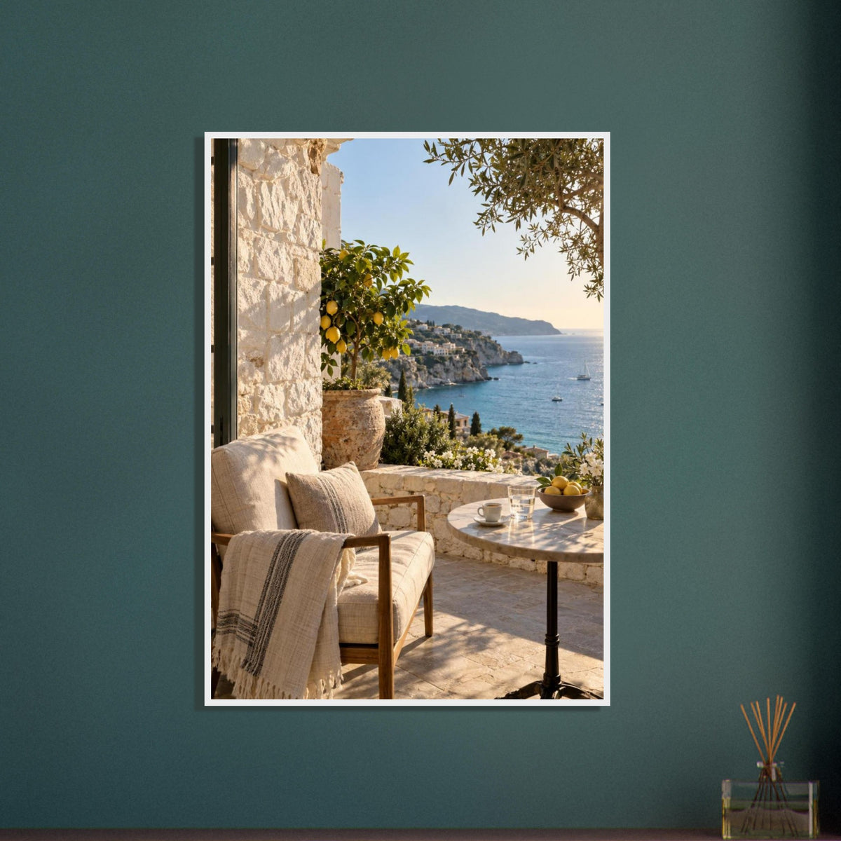 Lemon tree on a stone terrace with a cushioned chair, round table and blue sea overlooking a rocky coastline.