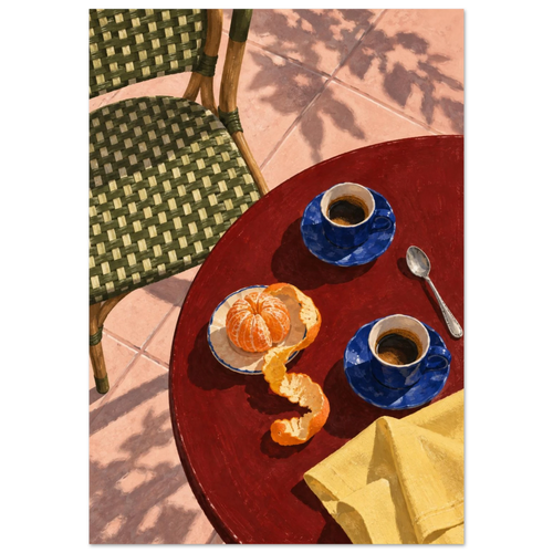 Two blue coffee cups, a peeled orange, spoon and yellow cloth on a red table beside a green woven chair and pink tiles.
