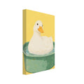 Cream-coloured duck with an orange bill bathing in a green tub of water against a textured yellow background.