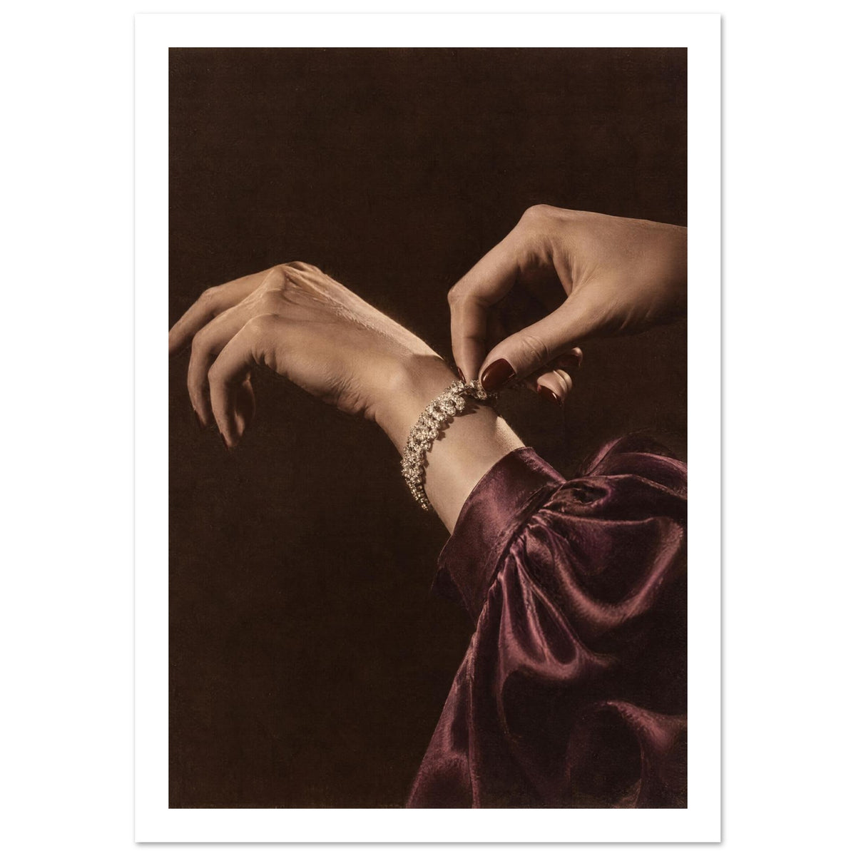 Hands adjusting a sparkling bracelet, with dark red nails and a gathered burgundy sleeve against a dark brown background.
