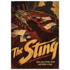 The Sting poster with a tipped glass, cards and gaming chips on a dark red table, a hatted shadow and gold lettering.