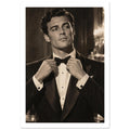 Man in a dark dinner jacket adjusting his bow tie, looking sideways, with blurred lights behind him in warm sepia tones.
