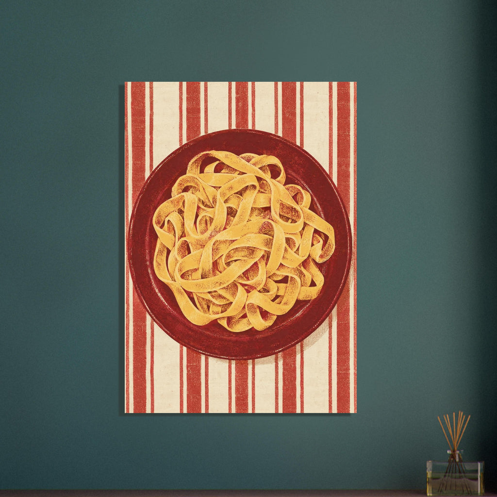 Golden pasta ribbons on a deep red plate, viewed from above against textured red and cream vertical stripes.