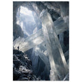 Giant translucent crystals cross a dark rocky cavern, with light entering above and a small figure standing on a ledge.