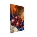 Three red onions and loose skins on blue and cream cloth beside a tilted copper pan against an orange background.