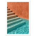 Stone steps descending into turquoise pool water beside a terracotta wall, with sunlight rippling across submerged stairs.