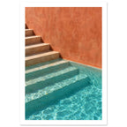 Stone steps descending into turquoise pool water beside a terracotta wall, with sunlight rippling across submerged stairs.